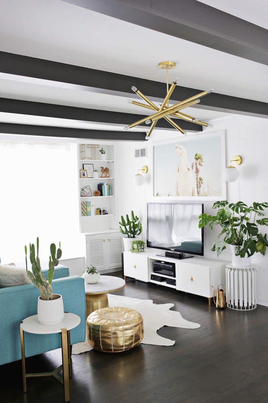 dark-wood-living-room-with-blue-couch-and-gold-starburst-light.jpg