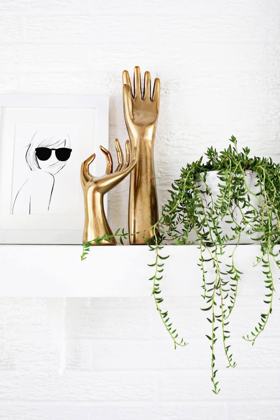 gold-hand-sculpture-against-white-brick-wall.jpg